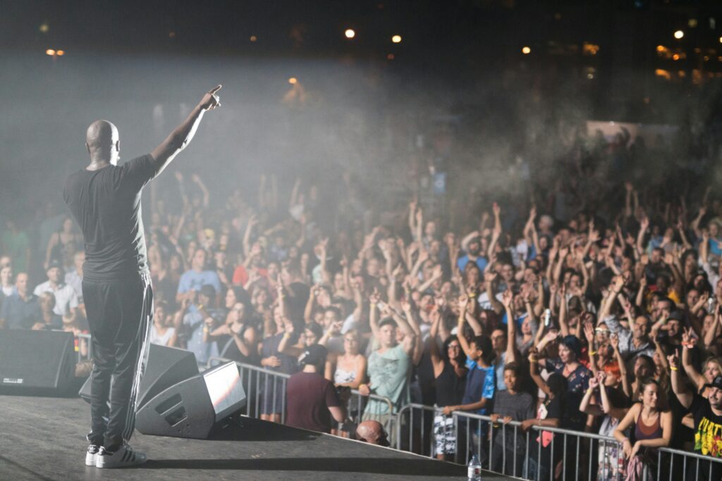 A performer standing on stage during a live music event.