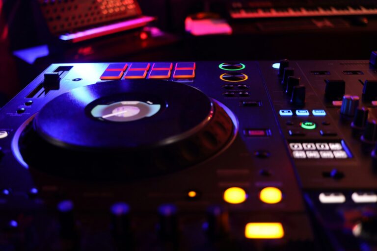A DJ turntable and mixer in a dark room.