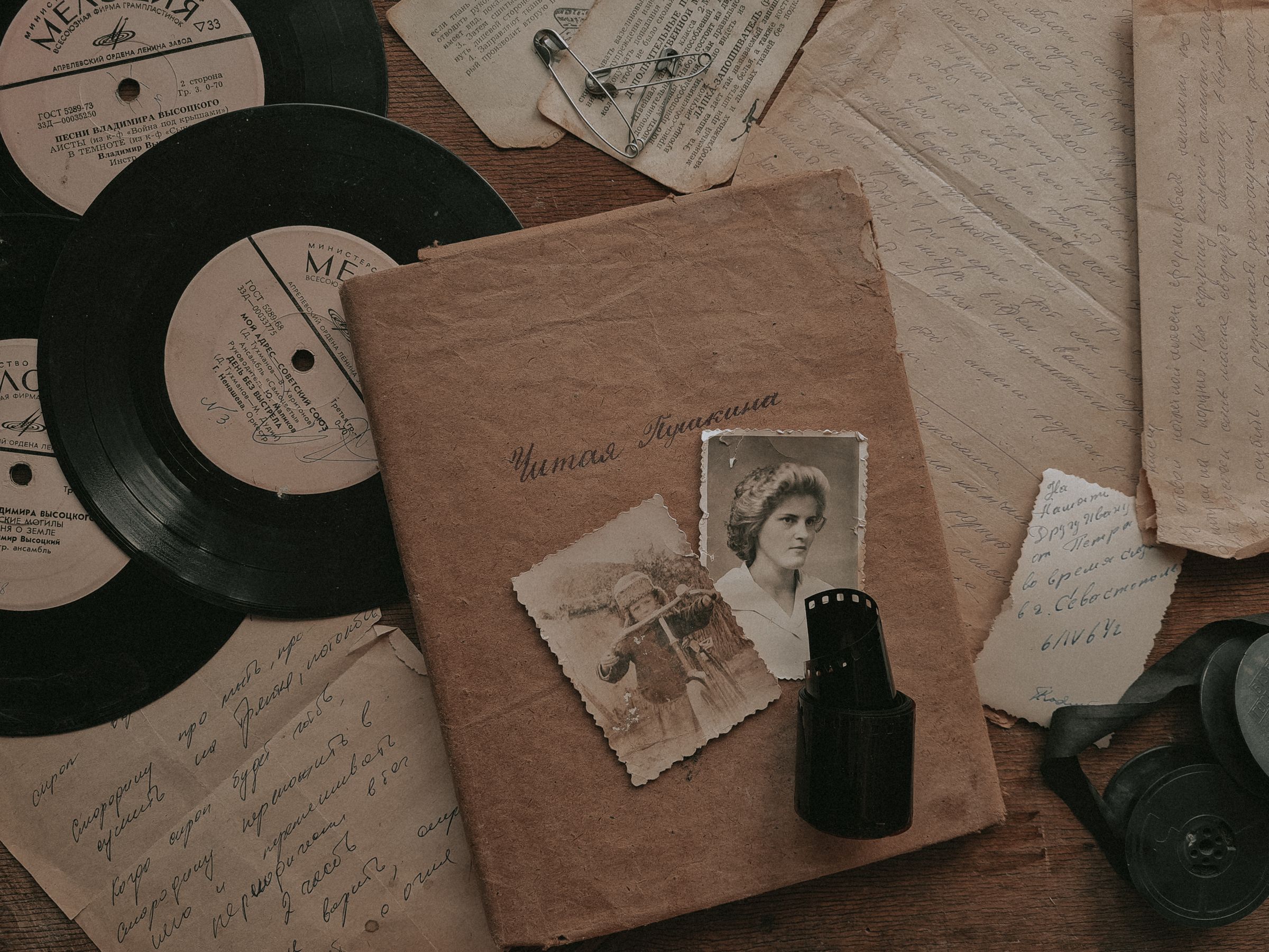 Vintage photographs, letters and records arranged on a table.